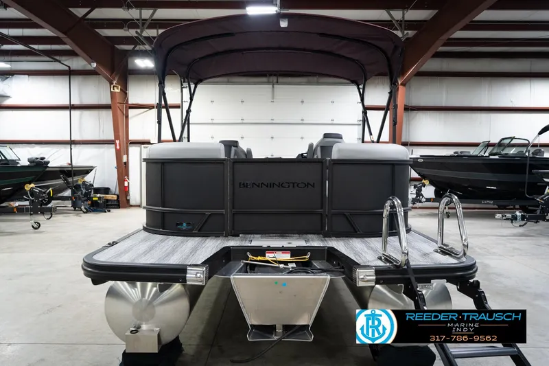 Slide: The Image of 2026 Bennington 23 SSR pontoon boat in showroom, rear view with canopy. - 8