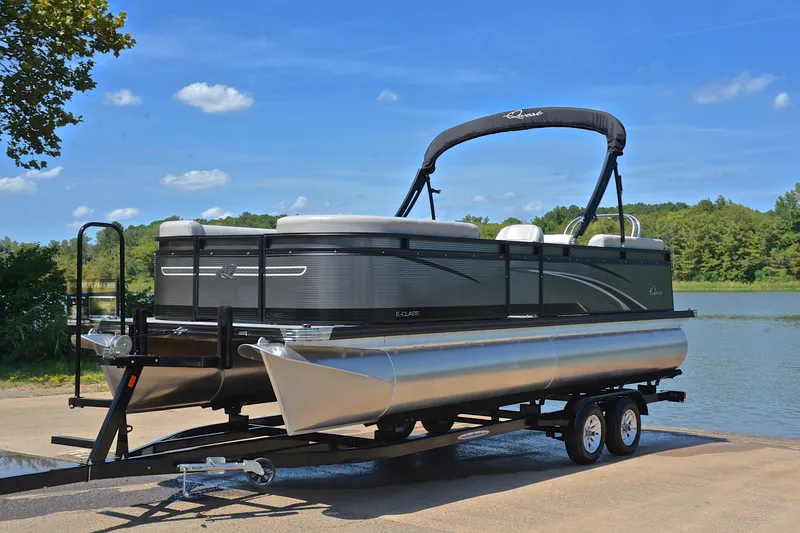 Slide: The Image of 2023 Qwest LT 822 pontoon boat on trailer by a scenic lake. - 10