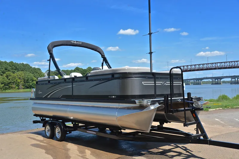 Slide: The Image of 2023 Qwest LT 822 pontoon boat on trailer by a scenic river. - 16