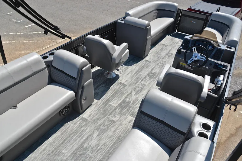 Slide: The Image of 2023 Qwest LT 822 pontoon boat interior with gray seating and modern dashboard. - 19