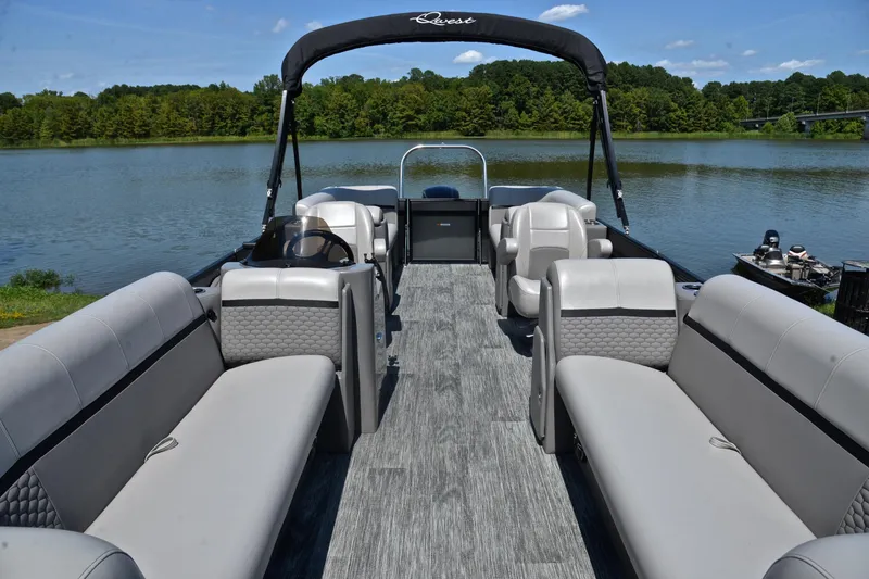 Slide: The Image of 2023 Qwest LT 822 pontoon boat with spacious seating on a serene lake. - 20