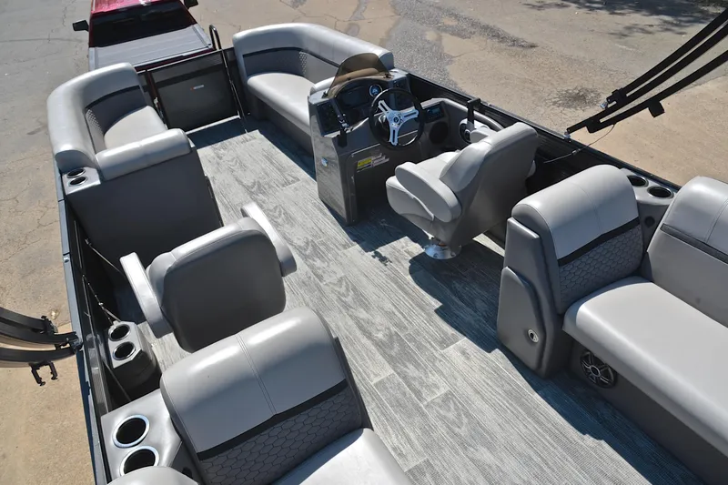 Slide: The Image of 2023 Qwest LT 822 pontoon boat interior with gray seating and modern steering console. - 23
