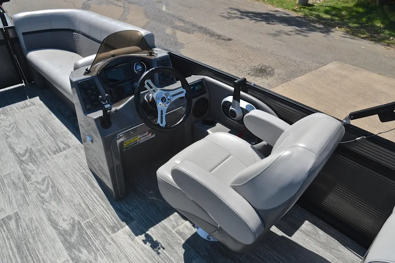 Slide: The Image of 2023 Qwest LT 822 boat interior with steering wheel and seating, featuring modern design. - 24