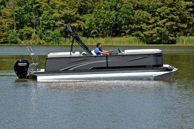 Slide: The Image of 2023 Qwest LT 822 pontoon boat cruising on a serene lake with lush greenery. - 6
