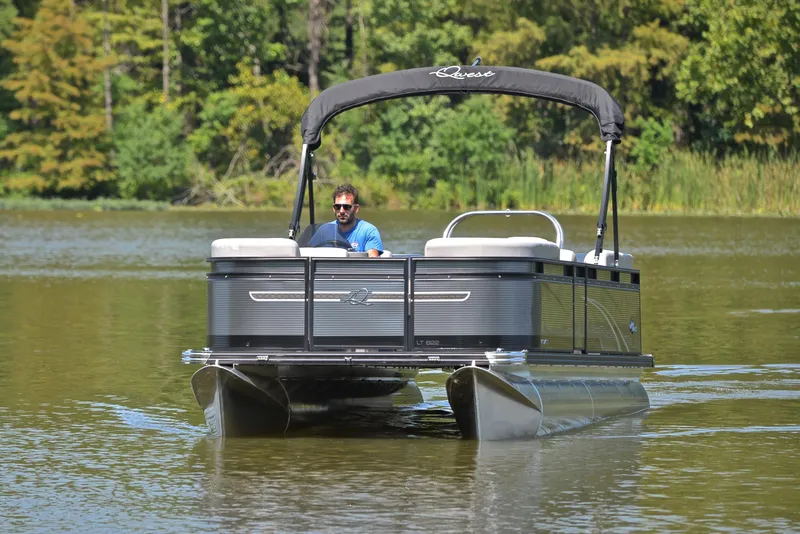 Slide: The Image of 2023 Qwest LT 822 pontoon boat cruising on a serene lake. - 9