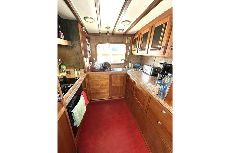 Slide: The Image of 1971 Southern Marine MALAHIDE Pilothouse LRC kitchen with wooden cabinets and modern appliances. - 15