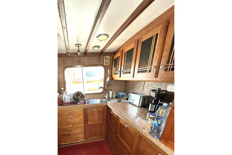 Slide: The Image of 1971 Southern Marine MALAHIDE Pilothouse LRC kitchen with wooden cabinets and modern appliances. - 16