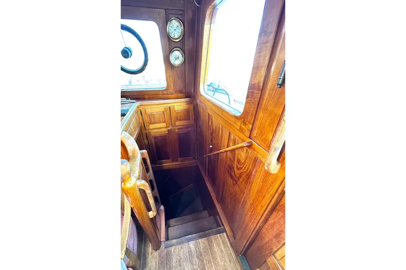 Slide: The Image of 1971 Southern Marine MALAHIDE Pilothouse LRC interior with wooden paneling and nautical instruments. - 20