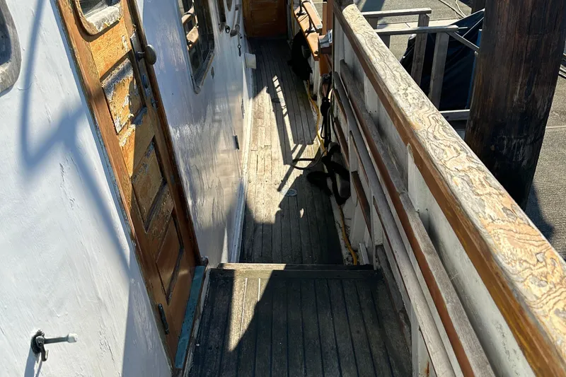 Slide: The Image of 1971 Southern Marine MALAHIDE Pilothouse LRC deck with wooden railings and door. - 3