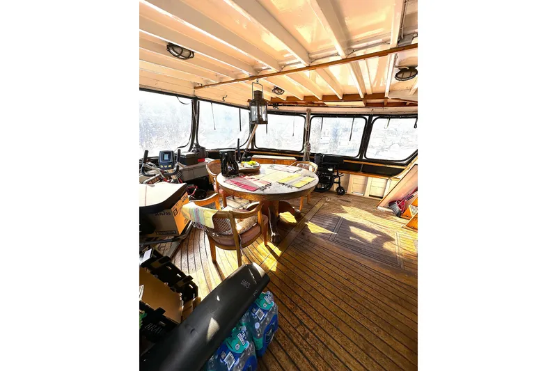 Slide: The Image of Pilothouse interior of 1971 Southern Marine MALAHIDE, featuring wooden flooring and panoramic windows. - 6