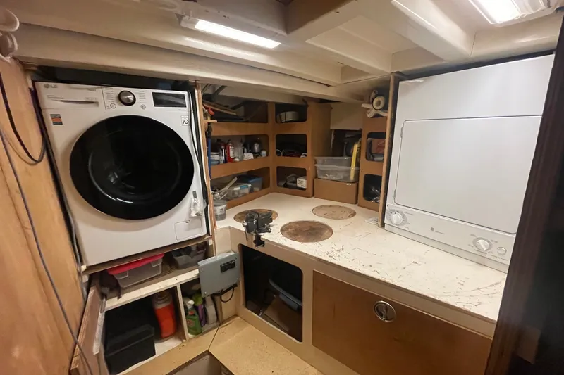 Slide: The Image of Laundry area in 1971 Southern Marine MALAHIDE Pilothouse LRC with washer, dryer, and storage shelves. - 37