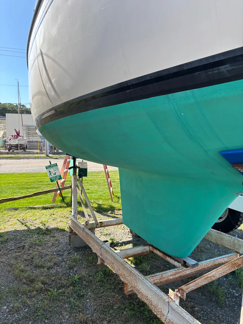 Slide: The Image of 1982 S2 8.5 sailboat on a trailer, showing hull and keel in a yard. - 9