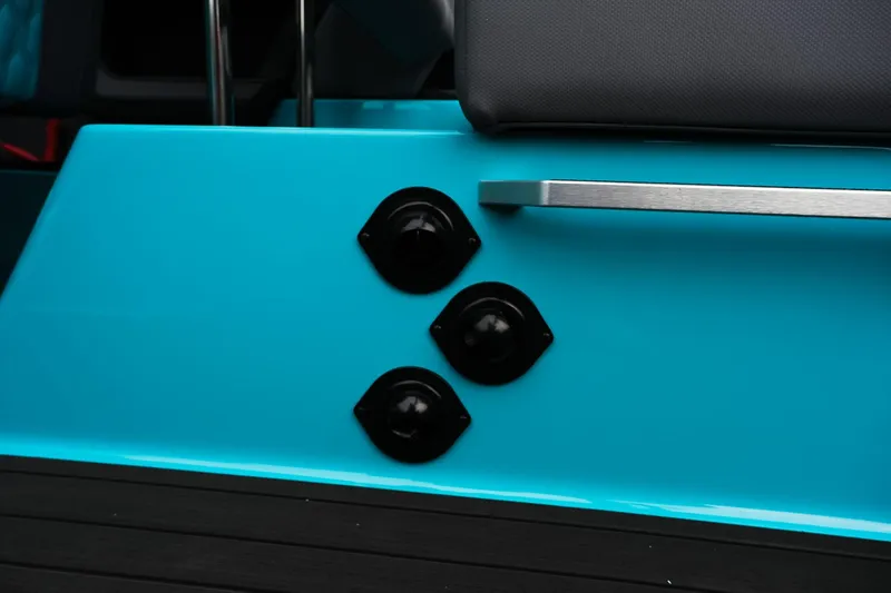 Slide: The Image of 2026 MasterCraft XT23 boat detail with teal finish and black fixtures. - 18