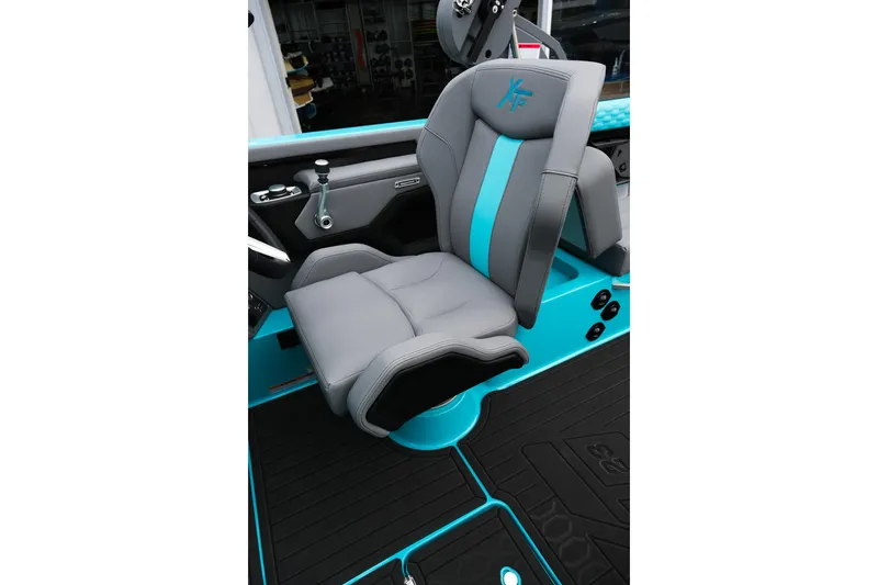 Slide: The Image of 2026 MasterCraft XT23 boat seat with gray and turquoise design, showcasing modern comfort. - 19
