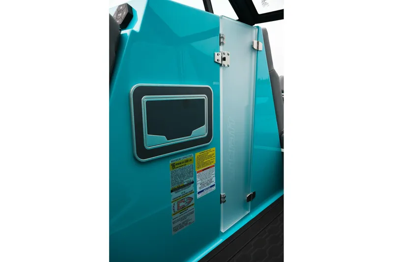 Slide: The Image of 2026 MasterCraft XT23 boat interior with teal panel and safety labels. - 21