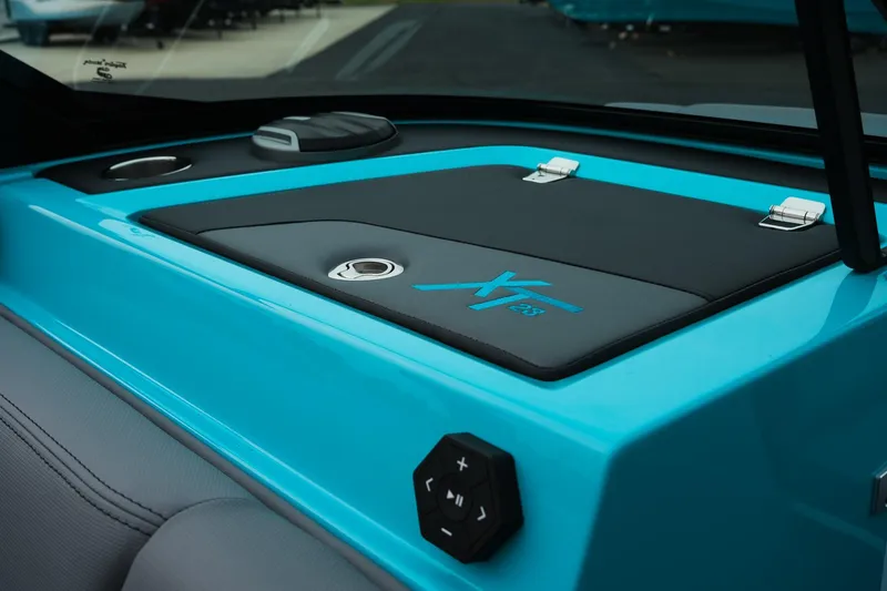 Slide: The Image of 2026 MasterCraft XT23 boat interior with sleek blue and black design details. - 22
