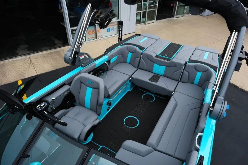 Slide: The Image of 2026 MasterCraft XT23 boat interior with sleek gray and turquoise seating design. - 30