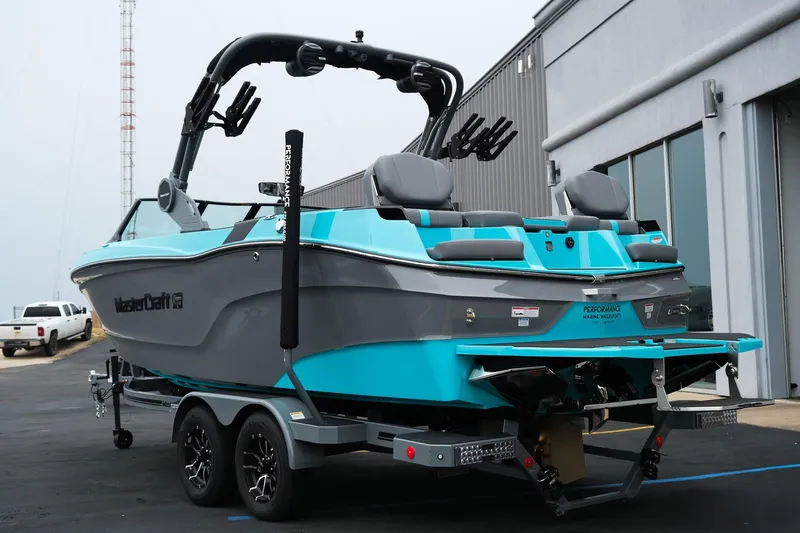 Slide: The Image of 2026 MasterCraft XT23 boat on trailer, featuring sleek design and vibrant blue accents. - 5
