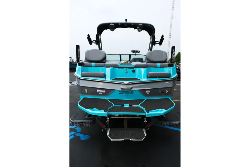 Slide: The Image of 2026 MasterCraft XT23 boat, rear view, featuring turquoise and gray design. - 7