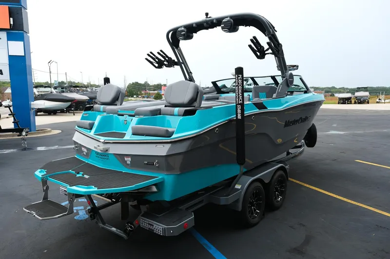 Slide: The Image of 2026 MasterCraft XT23 boat in a parking lot, featuring a sleek design and vibrant colors. - 8