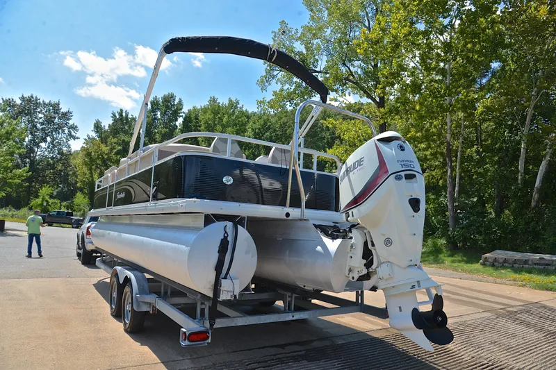 Slide: The Image of 2014 Godfrey SWEETWATER 2486 pontoon boat on trailer, parked near trees. - 11