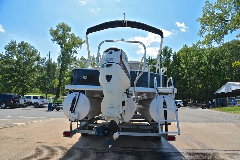 Slide: The Image of 2014 Godfrey SWEETWATER 2486 pontoon boat with Evinrude 150 engine at a boat launch. - 12
