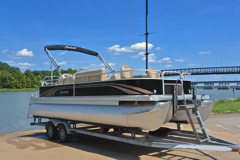 Slide: The Image of 2014 Godfrey SWEETWATER 2486 pontoon boat on trailer by a scenic river. - 15