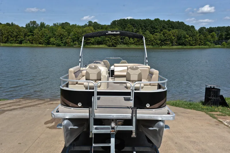 Slide: The Image of 2014 Godfrey SWEETWATER 2486 pontoon boat on trailer by a scenic lake. - 16