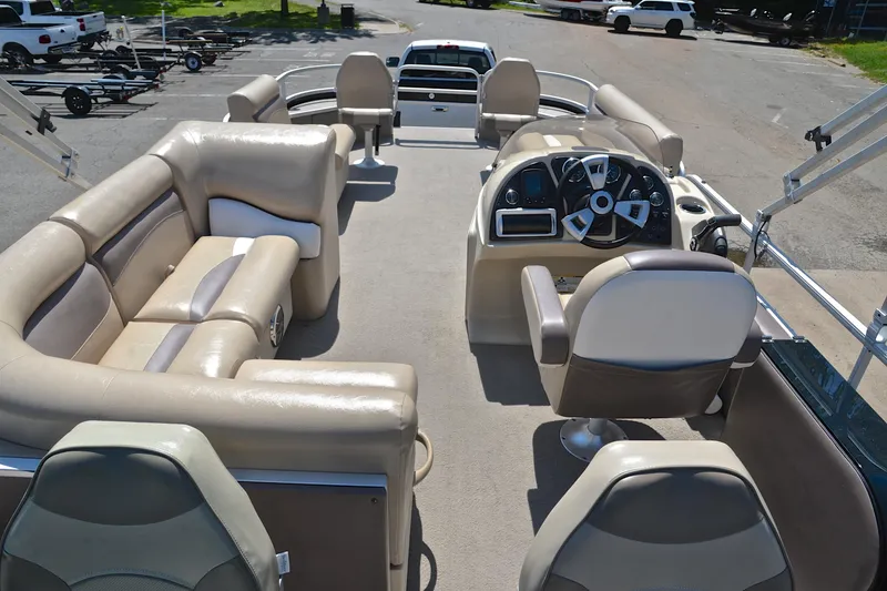 Slide: The Image of 2014 Godfrey SWEETWATER 2486 pontoon boat interior with beige seating and steering console. - 17