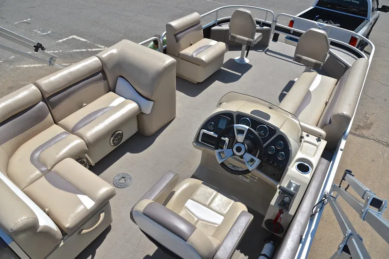 Slide: The Image of 2014 Godfrey SWEETWATER 2486 pontoon boat interior with beige seating and steering console. - 18