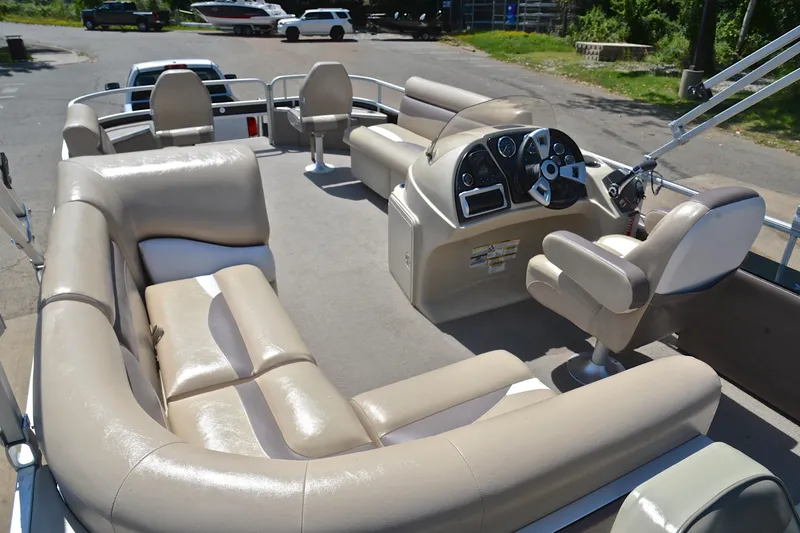 Slide: The Image of 2014 Godfrey SWEETWATER 2486 pontoon boat interior with beige seating and steering console. - 24