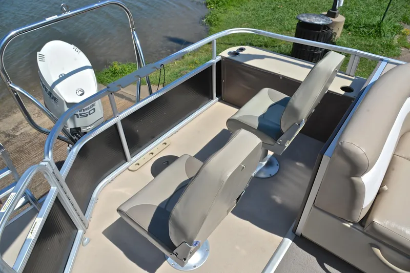 Slide: The Image of 2014 Godfrey SWEETWATER 2486 boat interior with seating and Evinrude 150 engine. - 25