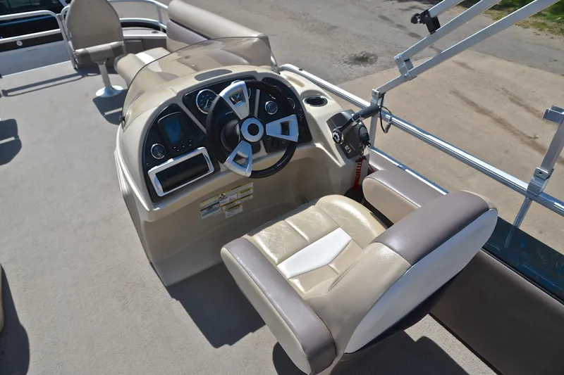 Slide: The Image of 2014 Godfrey SWEETWATER 2486 boat interior with steering console and seating. - 26