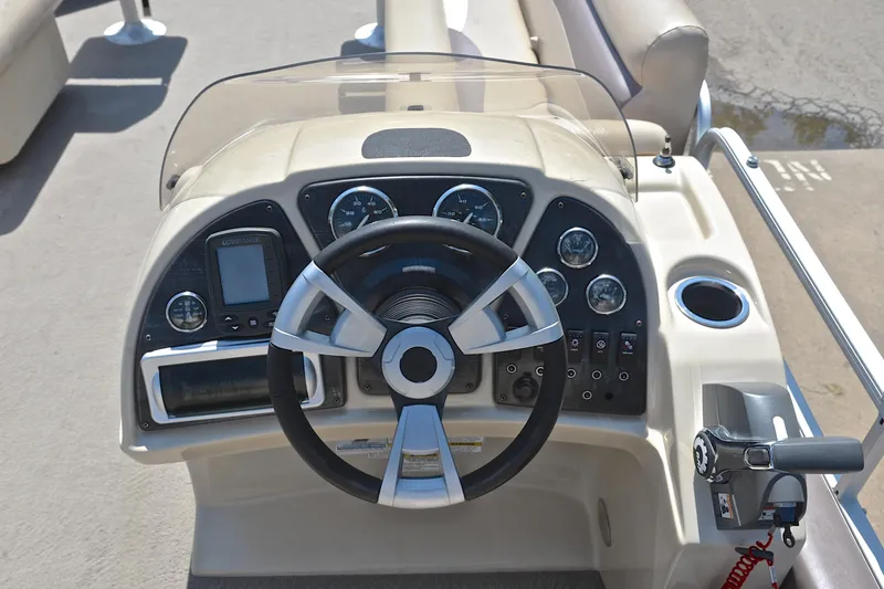 Slide: The Image of 2014 Godfrey SWEETWATER 2486 boat dashboard with steering wheel and control panel. - 27