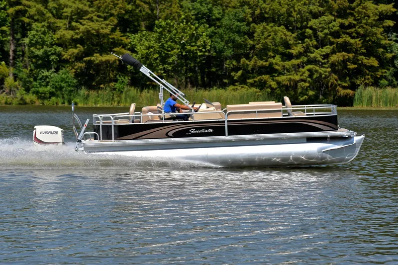 Slide: The Image of 2014 Godfrey SWEETWATER 2486 pontoon boat cruising on a scenic lake. - 3