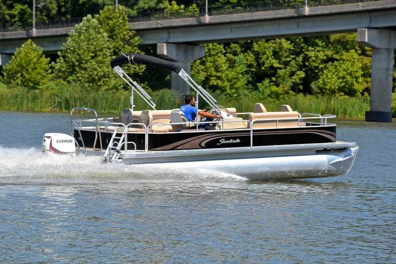 Slide: The Image of 2014 Godfrey SWEETWATER 2486 pontoon boat cruising on a river near a bridge. - 5