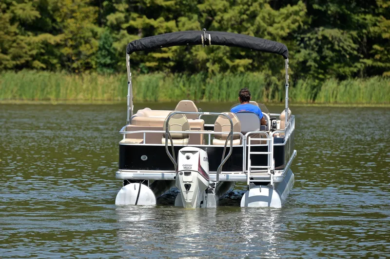 Slide: The Image of 2014 Godfrey SWEETWATER 2486 pontoon boat on a serene lake. - 7