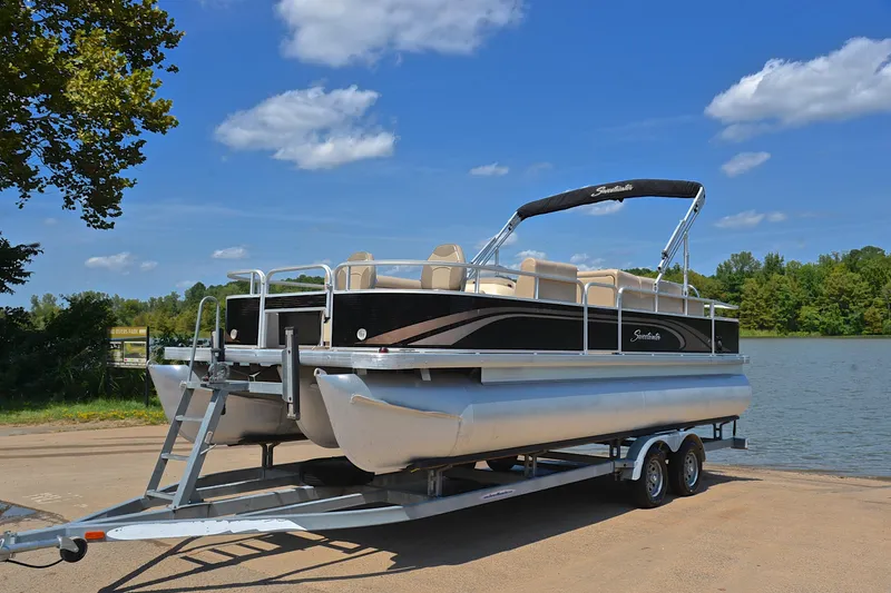 Slide: The Image of 2014 Godfrey SWEETWATER 2486 pontoon boat on trailer by a lake. - 9