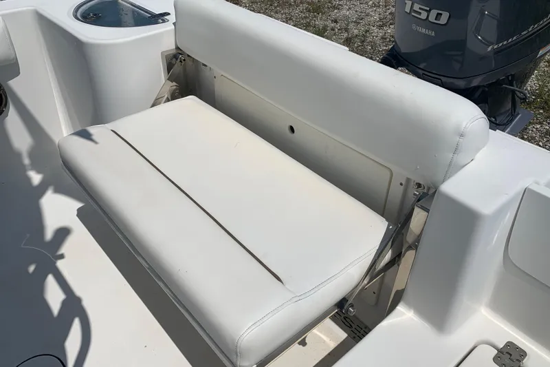 Slide: The Image of 2015 Sportsman Open 212 Center Console boat with white seating and Yamaha 150 engine. - 11