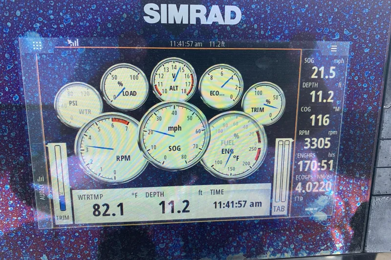 Slide: The Image of Simrad display on 2015 Sportsman Open 212 Center Console showing engine metrics and navigation data. - 13