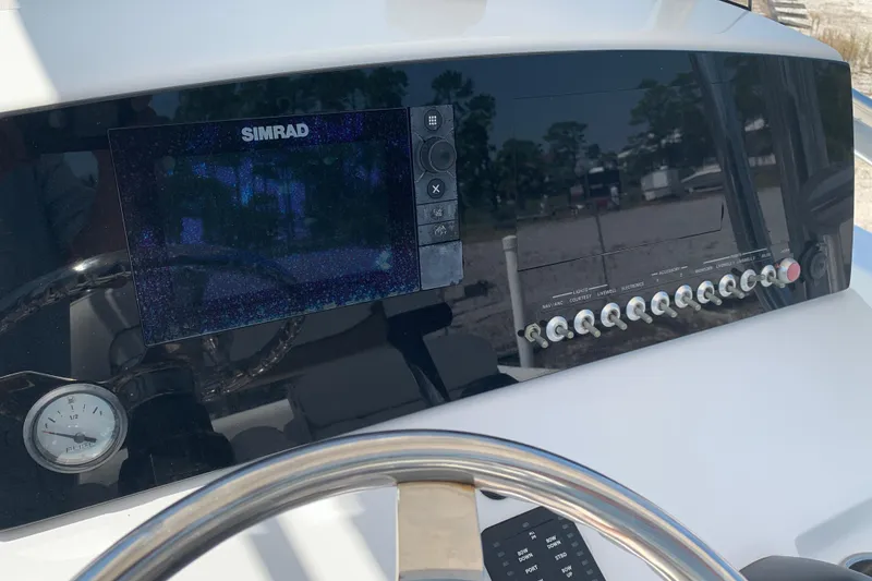 Slide: The Image of Control panel of a 2015 Sportsman Open 212 Center Console boat with Simrad display. - 14