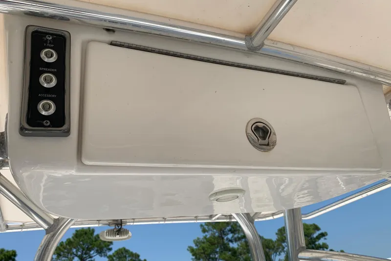 Slide: The Image of 2015 Sportsman Open 212 Center Console boat dashboard with control panel and storage compartment. - 17