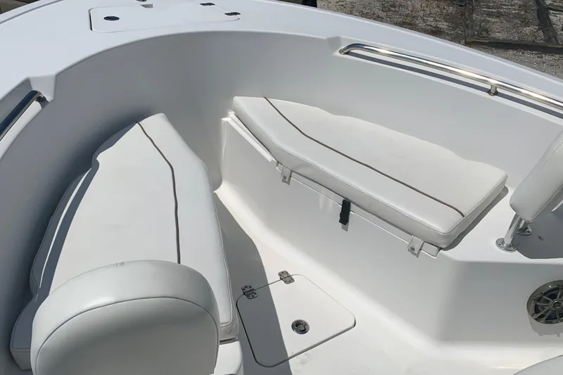 Slide: The Image of 2015 Sportsman Open 212 Center Console boat interior with white cushioned seating. - 20