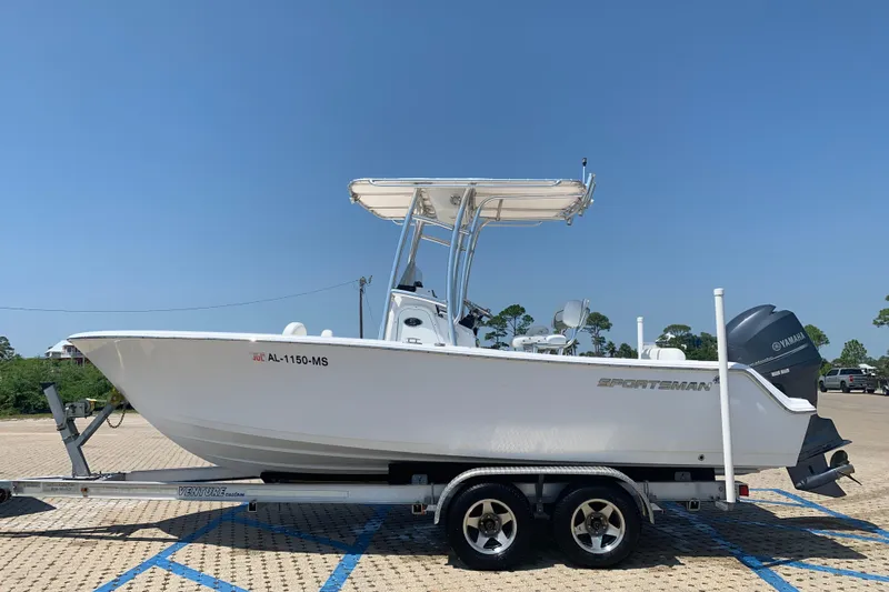 Slide: The Image of 2015 Sportsman Open 212 Center Console boat on trailer, parked outdoors. - 6