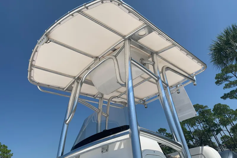 Slide: The Image of 2015 Sportsman Open 212 Center Console boat with T-top under clear blue sky. - 7