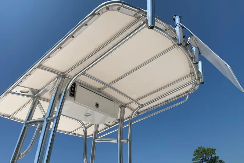 Slide: The Image of 2015 Sportsman Open 212 Center Console T-top against clear blue sky. - 8
