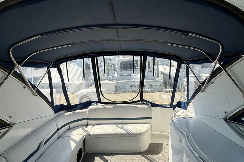 Slide: The Image of Interior view of a 1999 Formula 400 Super Sport boat with blue canopy and white seating. - 12