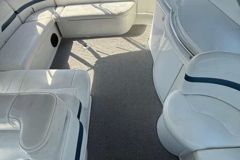 Slide: The Image of Interior of a 1999 Formula 400 Super Sport boat with white seating and carpet. - 13