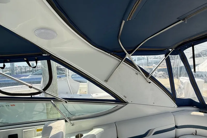 Slide: The Image of Interior view of a 1999 Formula 400 Super Sport boat with blue canopy and seating. - 16
