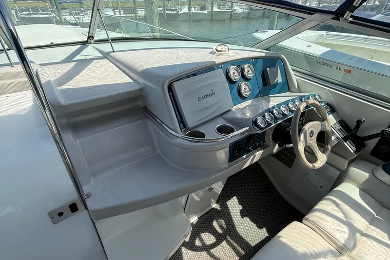 Slide: The Image of 1999 Formula 400 Super Sport boat dashboard with Garmin navigation system and steering wheel. - 20